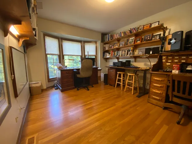 a living room with furniture a fireplace and a large window