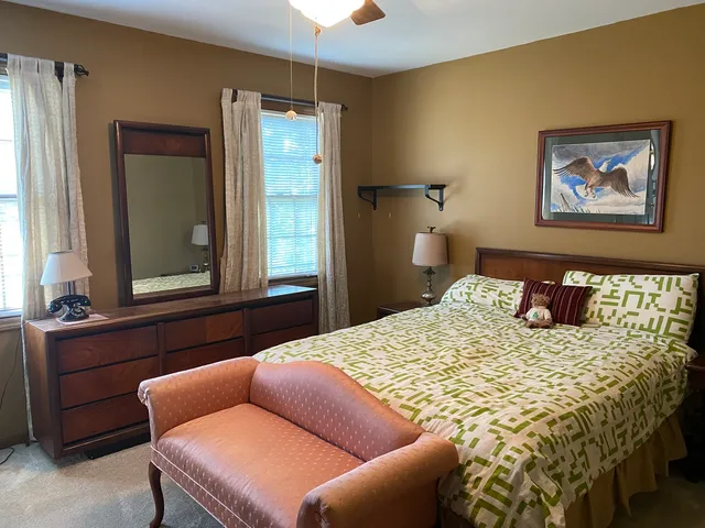 a bathroom with a toilet and a mirror