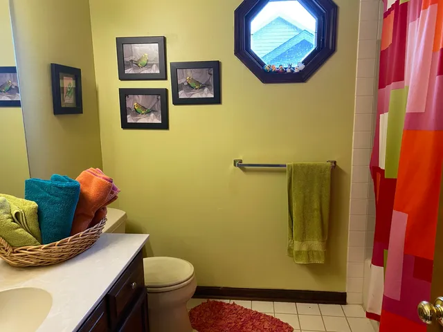 a kitchen with a stove a sink and a dining table with wooden floor