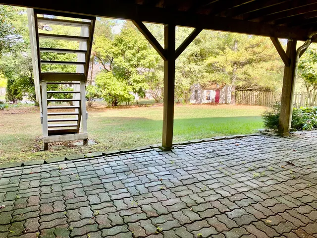 a view of a house with a garden and deck