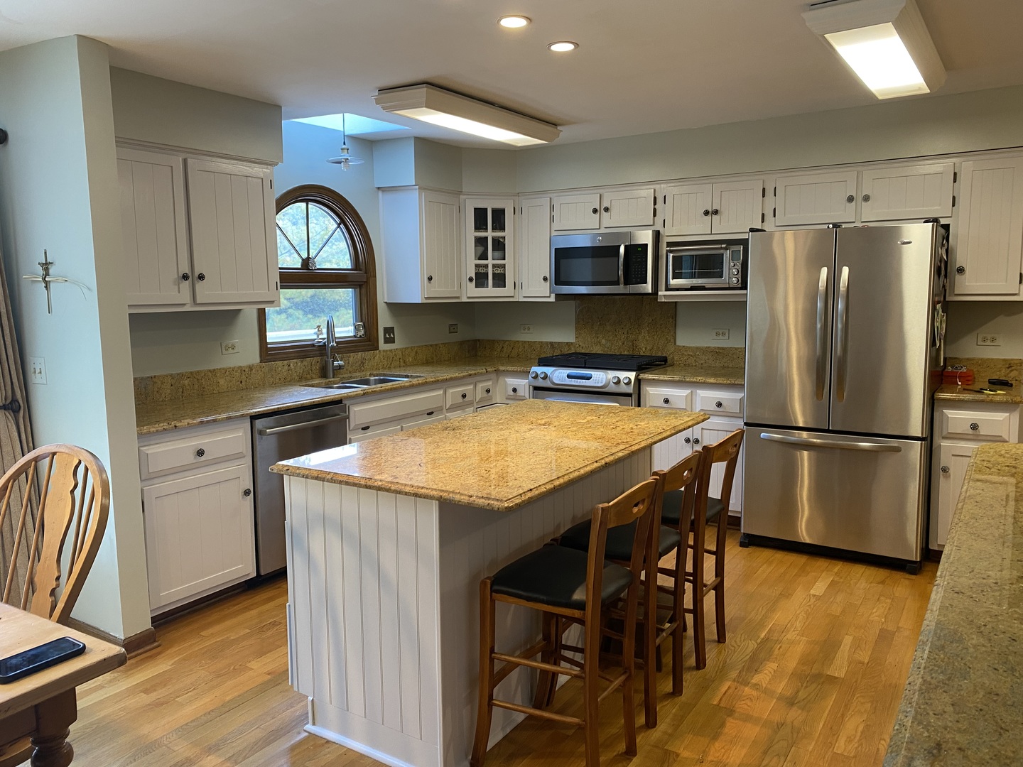 621 Young Avenue Batavia, IL 60510 - Photo 6 of 32 a kitchen with stainless steel appliances granite countertop a table chairs refrigerator and sink