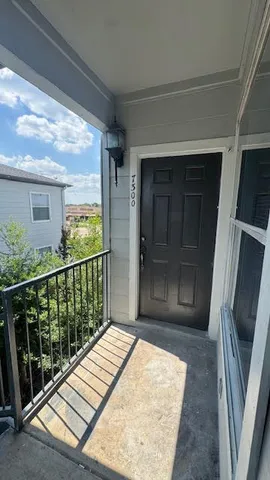 a view of balcony with floor to ceiling window and wooden floor