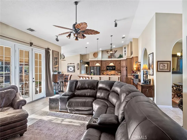 a kitchen with stainless steel appliances kitchen island granite countertop a sink and a fireplace