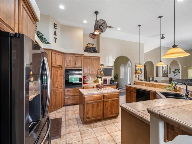 a kitchen with a refrigerator and a stove