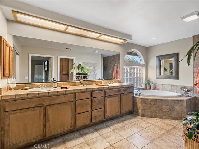 a bathroom with a tub sink and mirror