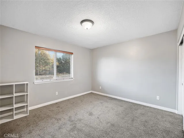 a bathroom with a granite countertop toilet sink and mirror