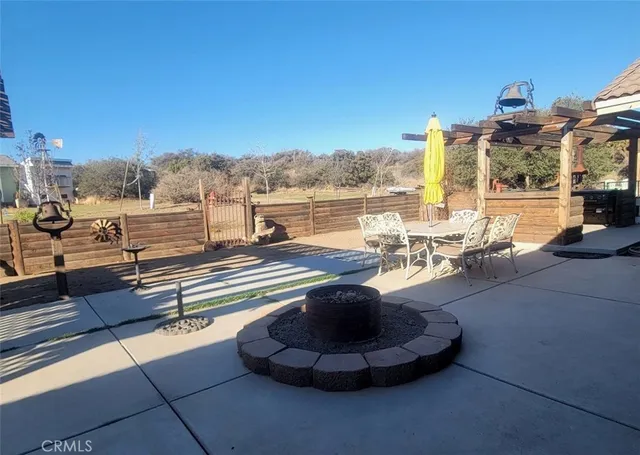 a view of an chairs and tables in the back yard of the house