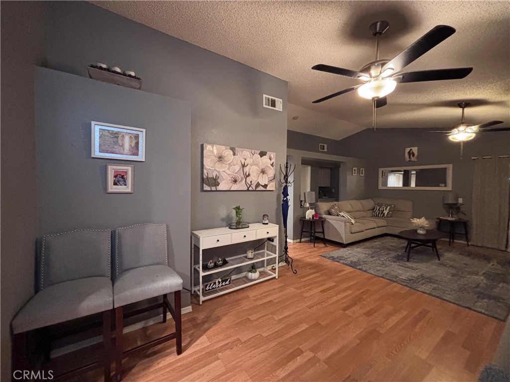 560 Coudures Way Perris, CA 92571 - Photo 14 of 35 a living room with furniture and a chandelier