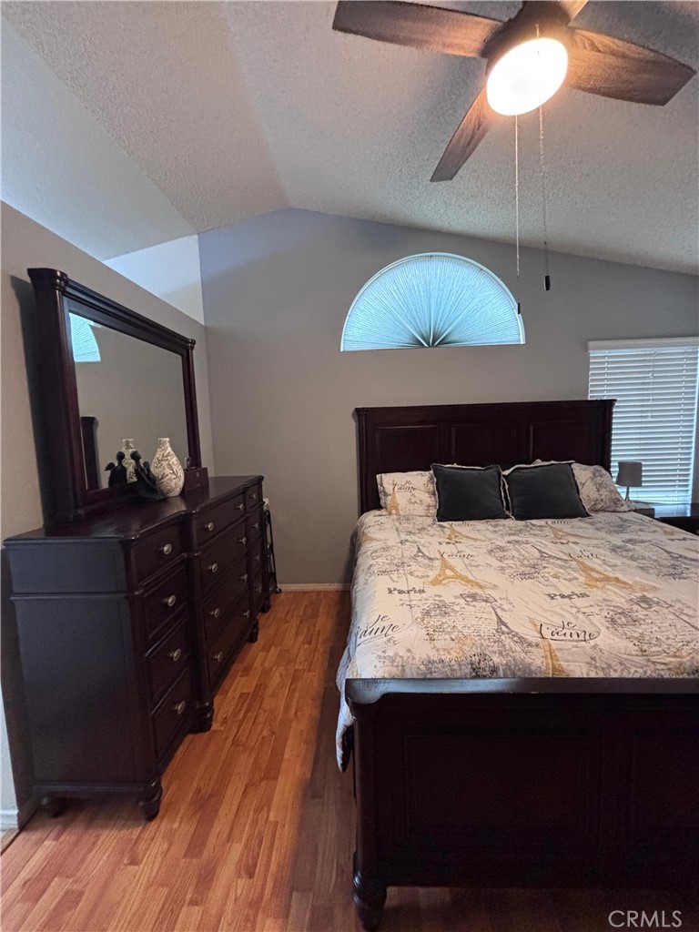 560 Coudures Way Perris, CA 92571 - Photo 17 of 35 a bedroom with a bed and a mirror on dresser
