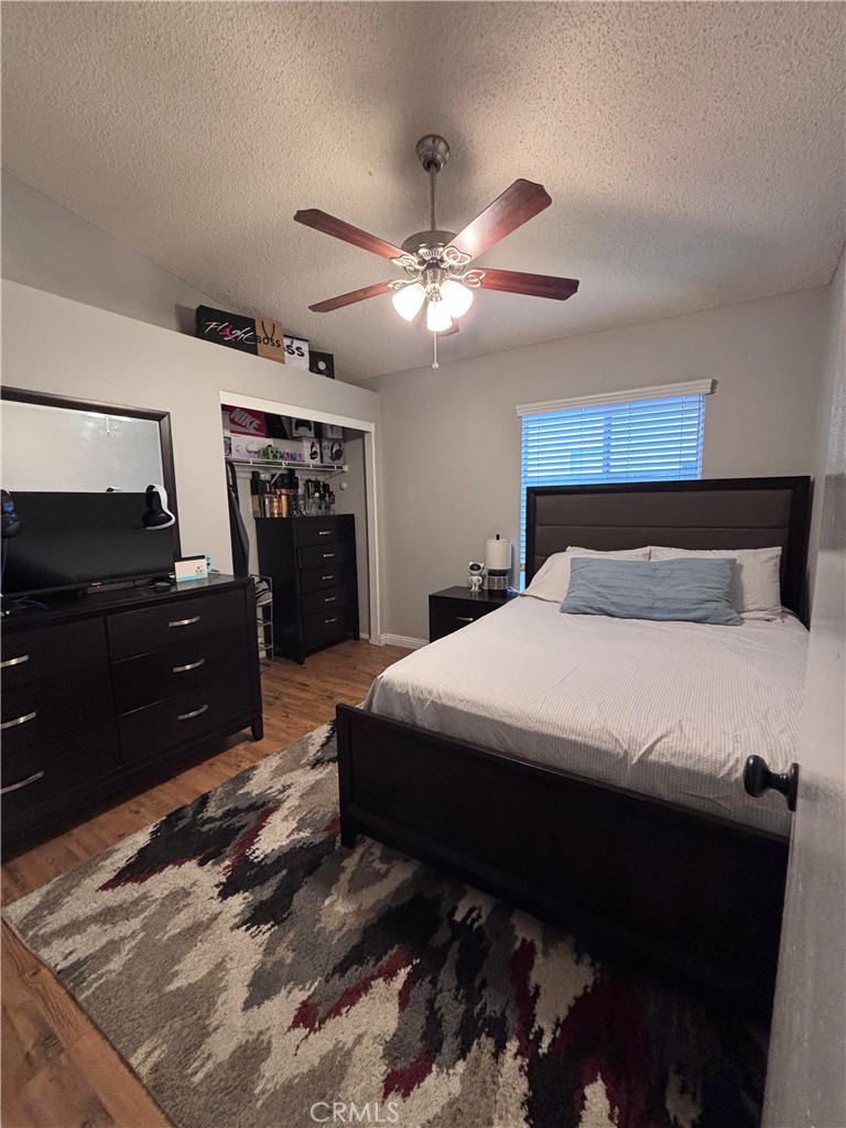 560 Coudures Way Perris, CA 92571 - Photo 19 of 35 a bedroom with a bed and a television