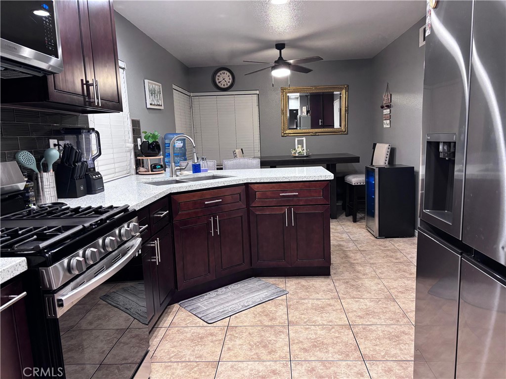 560 Coudures Way Perris, CA 92571 - Photo 26 of 35 a kitchen with a sink stainless steel appliances and cabinets