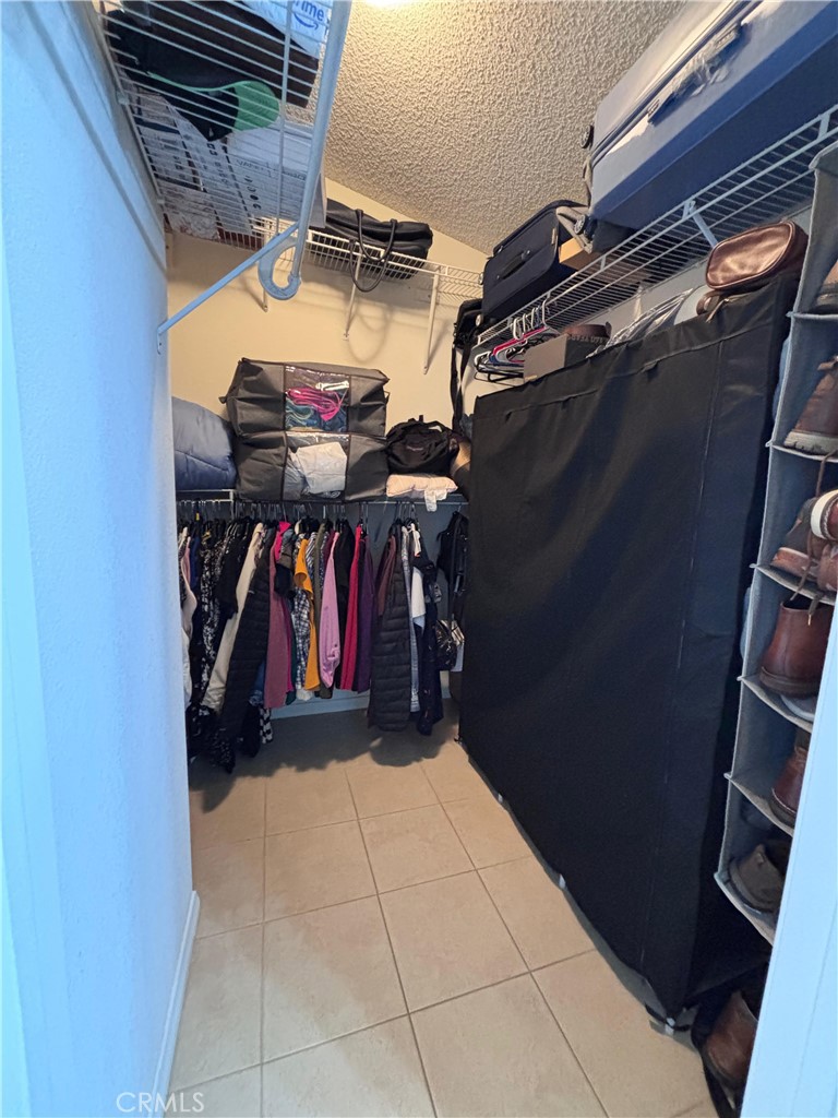 560 Coudures Way Perris, CA 92571 - Photo 4 of 35 a view of walk in closet with clothes and shoes