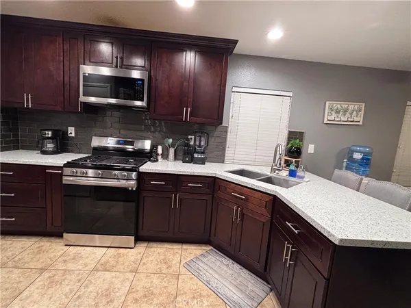 a kitchen with a sink stove and microwave