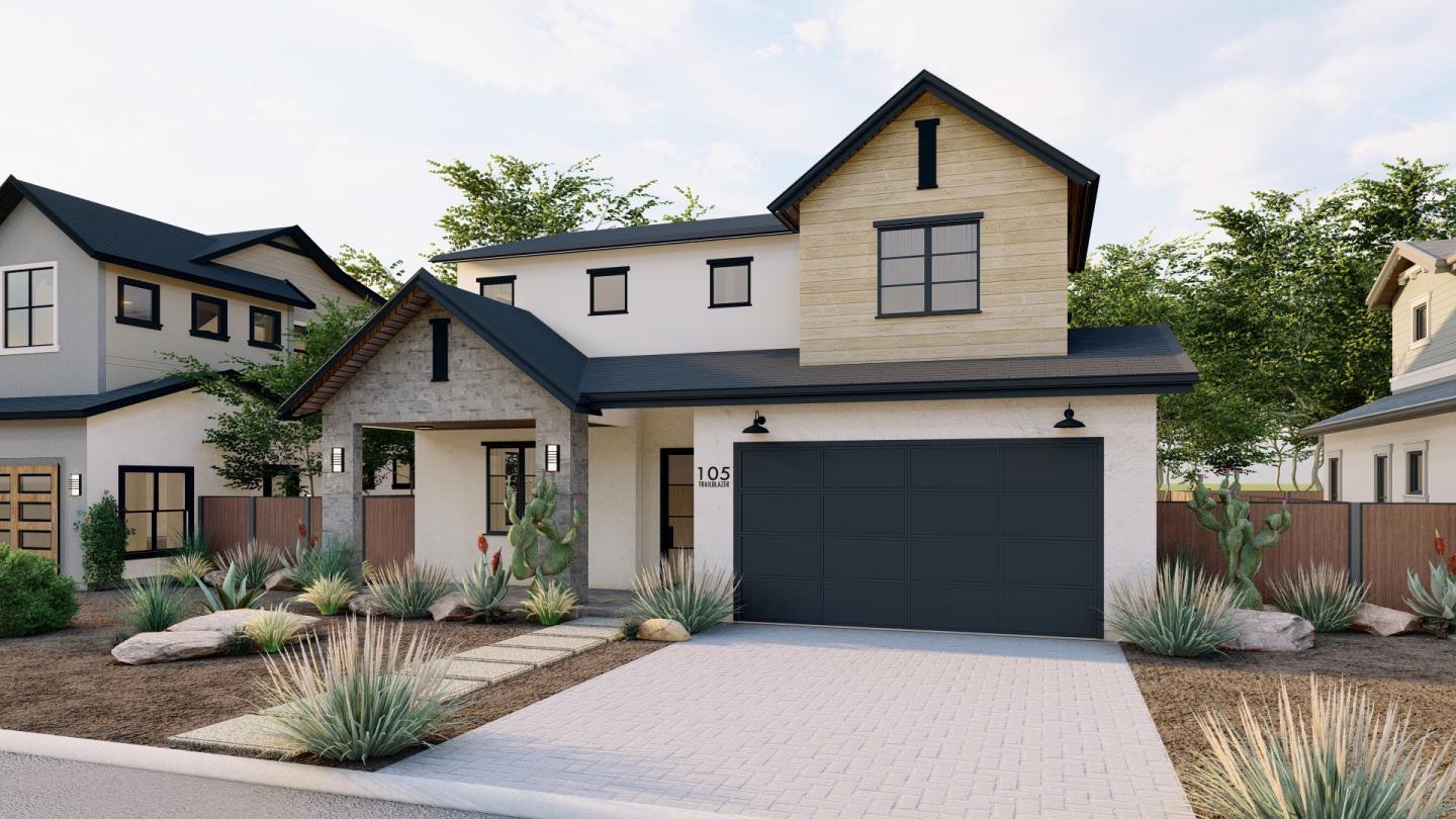 a front view of a house with a yard and potted plants