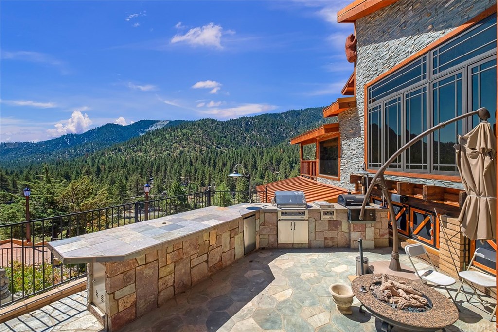 488 Highway 2 Wrightwood, CA 92397 - Photo 11 of 54 a view of a patio with couches table and chairs and potted plants