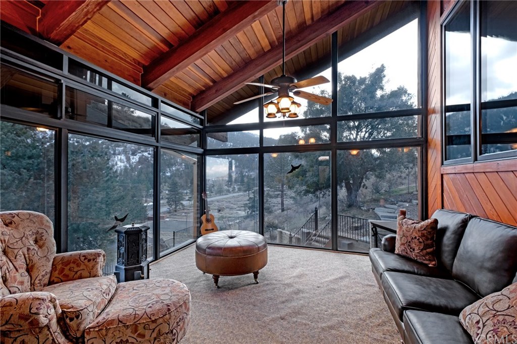 488 Highway 2 Wrightwood, CA 92397 - Photo 17 of 54 a living room with furniture a floor to ceiling window and potted plants