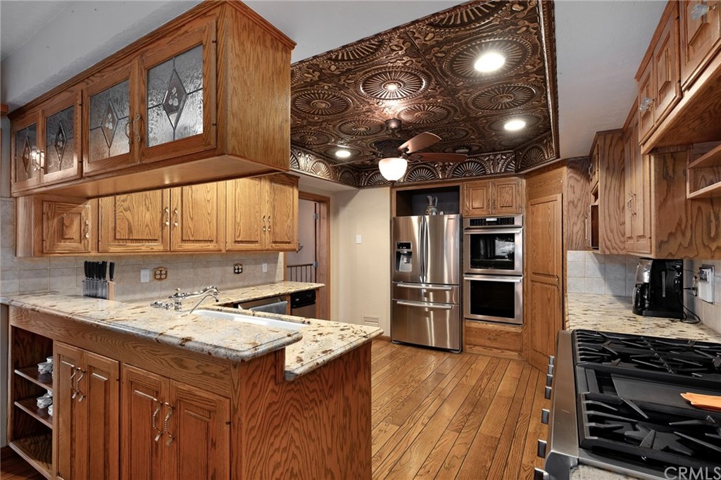 488 Highway 2 Wrightwood, CA 92397 - Photo 24 of 54 a kitchen that has a lot of cabinets a sink and appliances