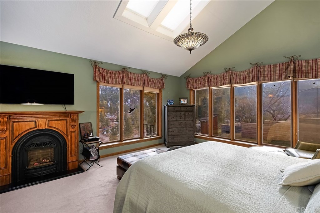 488 Highway 2 Wrightwood, CA 92397 - Photo 36 of 54 a bedroom with a bed and glass walk in closet