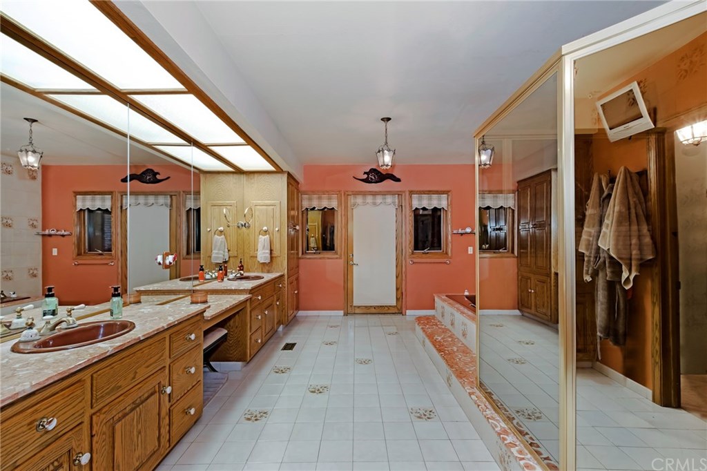 488 Highway 2 Wrightwood, CA 92397 - Photo 37 of 54 a large bathroom with a double vanity sink a large mirror and a shower