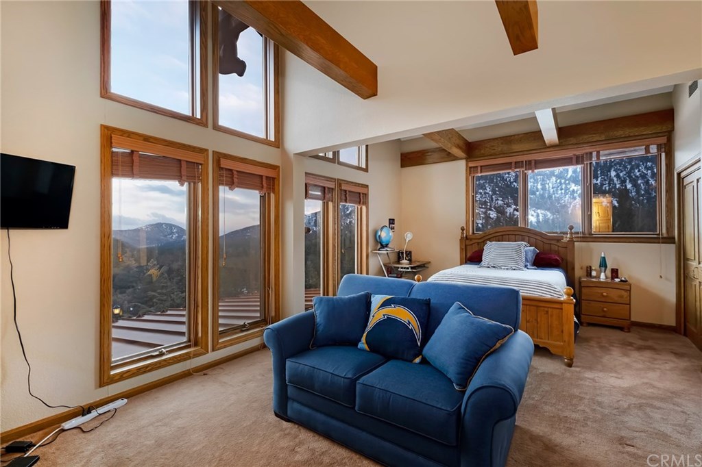 488 Highway 2 Wrightwood, CA 92397 - Photo 43 of 54 a living room with furniture a flat screen tv and floor to ceiling window