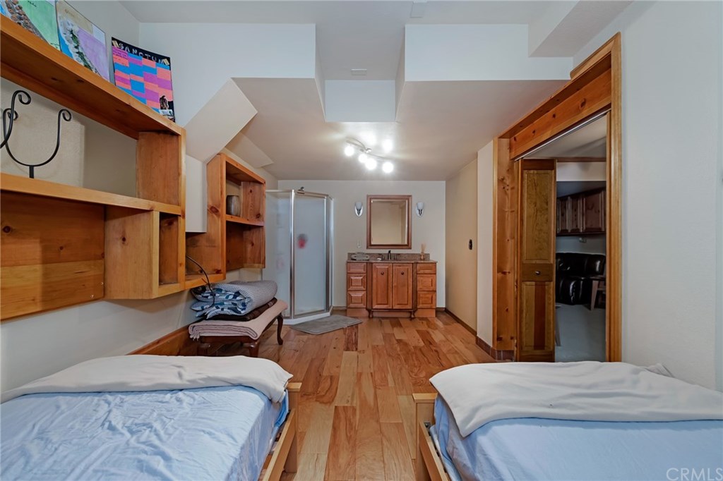 488 Highway 2 Wrightwood, CA 92397 - Photo 49 of 54 a bedroom with furniture and a book shelf