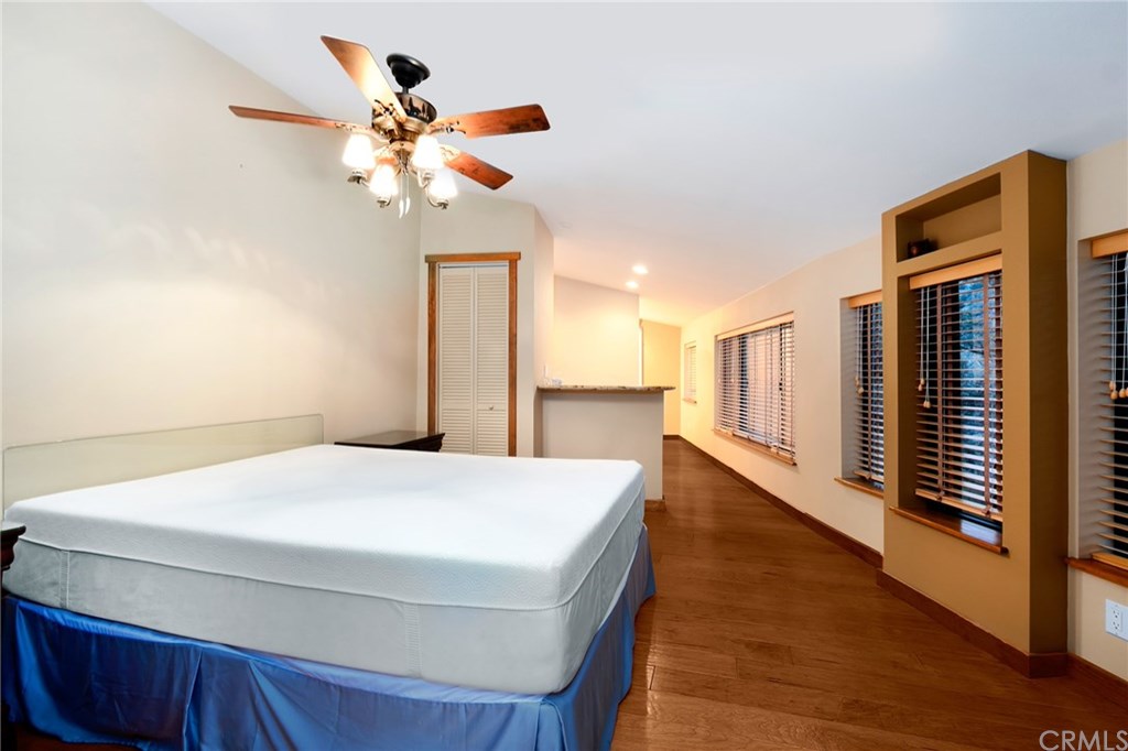 488 Highway 2 Wrightwood, CA 92397 - Photo 52 of 54 a bedroom with a bed and a chandelier