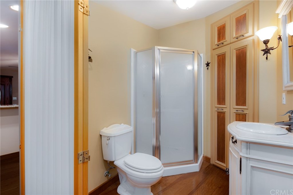 488 Highway 2 Wrightwood, CA 92397 - Photo 54 of 54 a bathroom with a granite countertop toilet a sink and a mirror