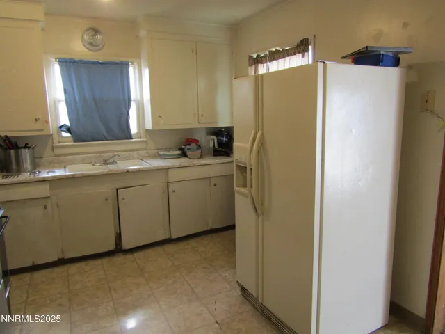 a living room with furniture a rug and gym equipment