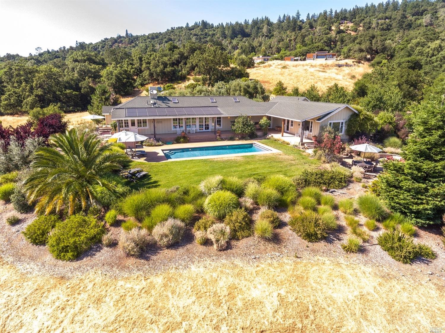 a view of a swimming pool with two chairs
