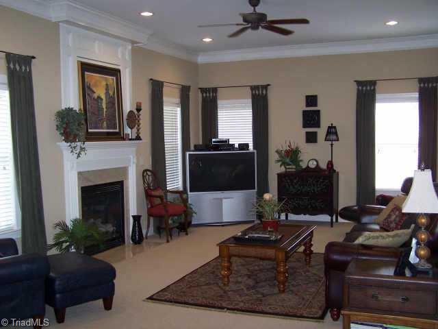 7805 Wilson Farm Road Summerfield, NC 27358 - Photo 4 of 9 Other. The Great Room has a gas log fireplace with a tv niche with recessed doors.