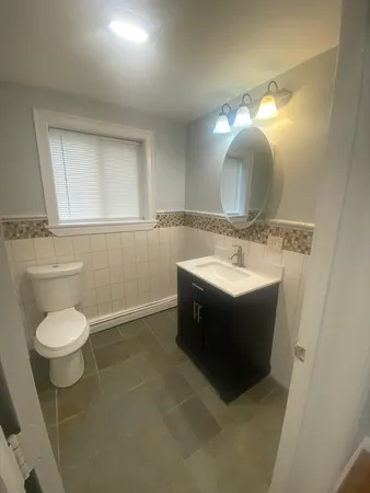 a bathroom with a sink toilet and mirror