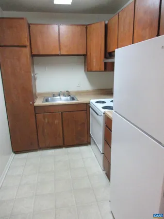 a kitchen with granite countertop a cabinets and a stove top oven