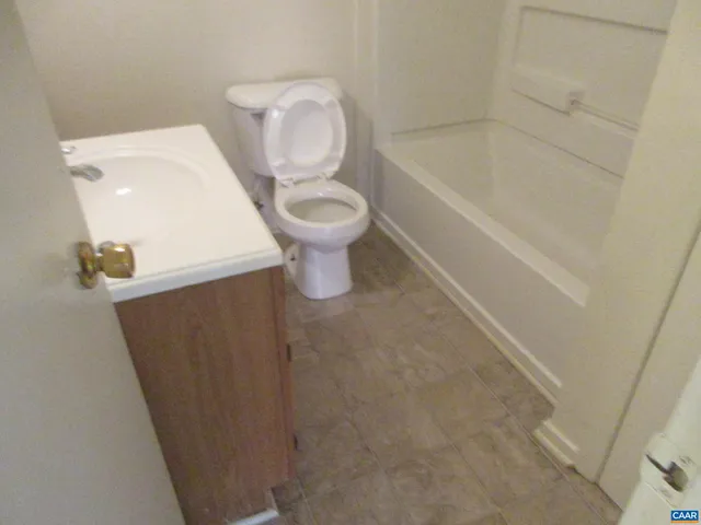 a bathroom with a toilet and bathtub