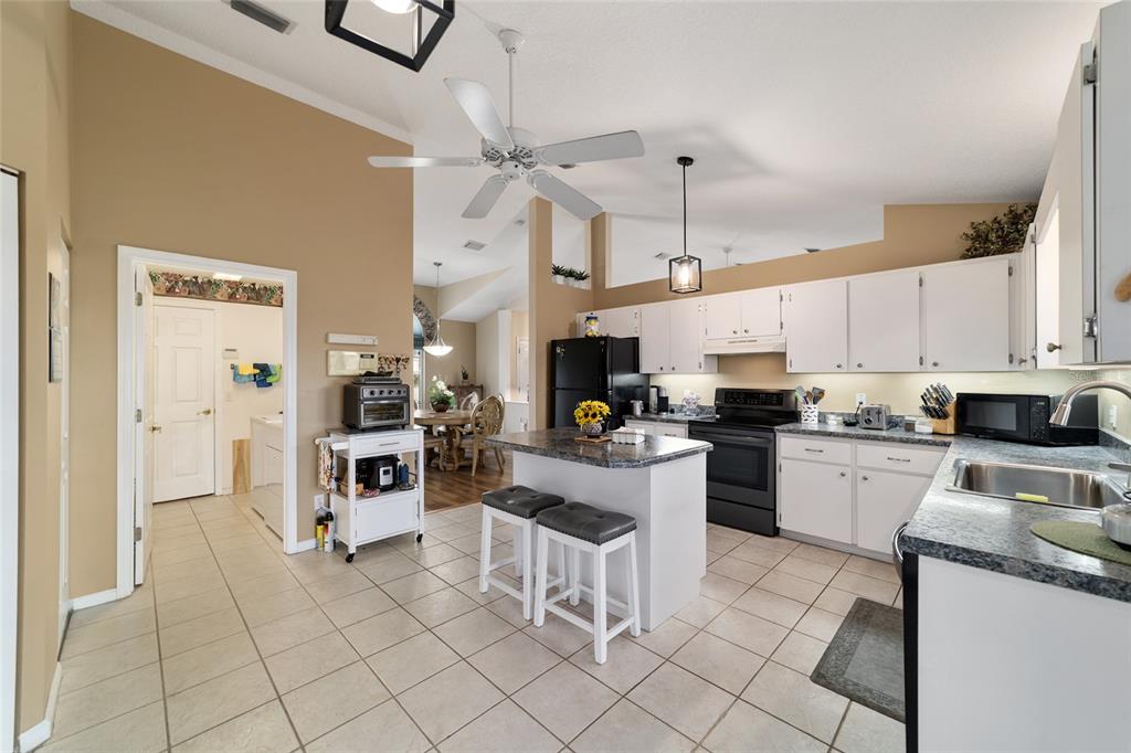 5245 Northwest 21st Loop Ocala, FL 34482 - Photo 11 of 26 a kitchen with cabinets and chairs