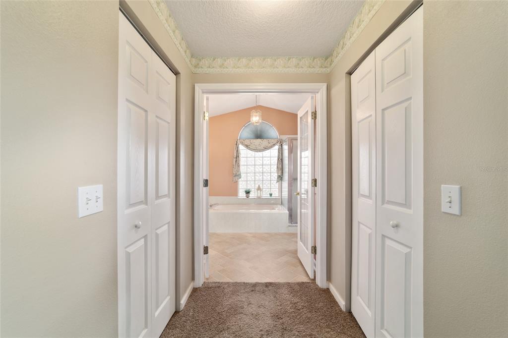 5245 Northwest 21st Loop Ocala, FL 34482 - Photo 15 of 26 a view of a hallway with a livingroom and a bathroom with bathtub