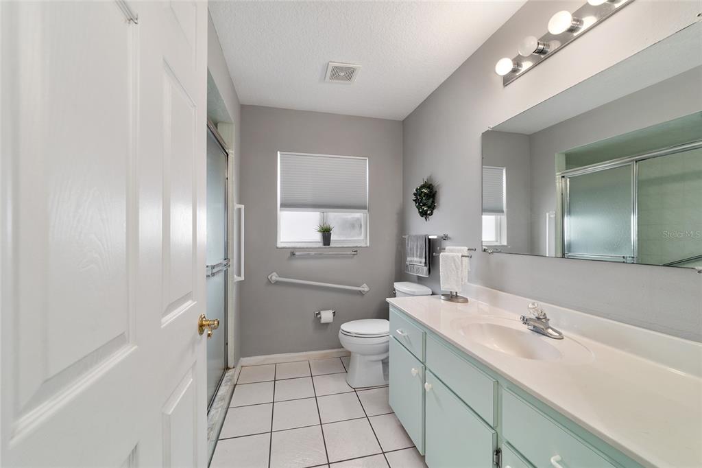 5245 Northwest 21st Loop Ocala, FL 34482 - Photo 18 of 26 a bathroom with a sink a toilet and shower