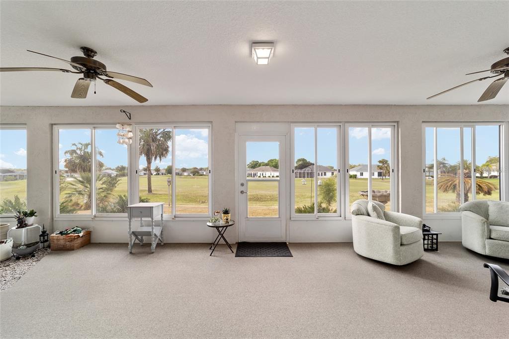 5245 Northwest 21st Loop Ocala, FL 34482 - Photo 23 of 26 a living room with furniture and large windows