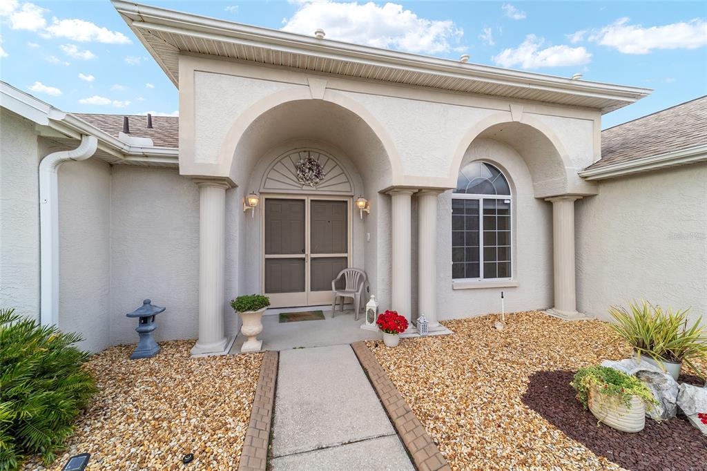 5245 Northwest 21st Loop Ocala, FL 34482 - Photo 3 of 26 a front view of a house with garden