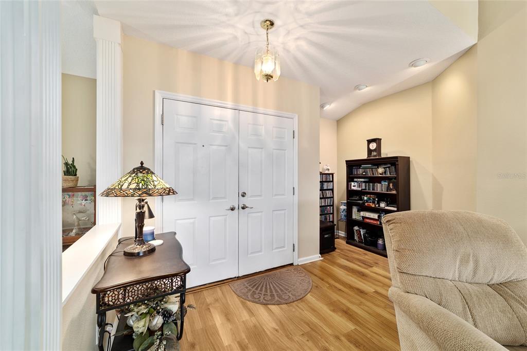 5245 Northwest 21st Loop Ocala, FL 34482 - Photo 4 of 26 a bedroom with furniture and a chandelier