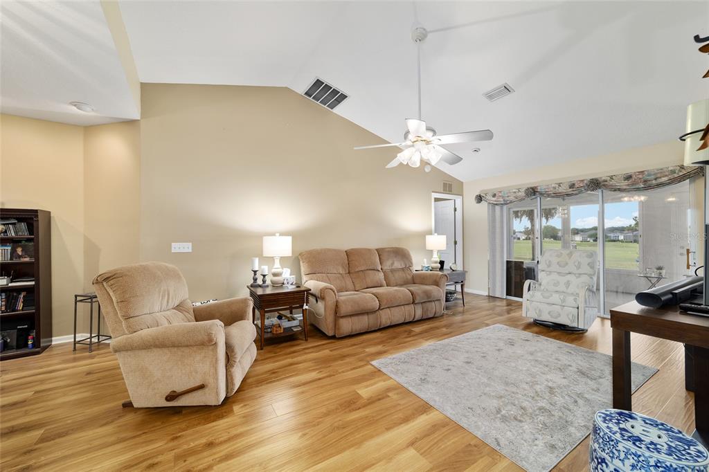 5245 Northwest 21st Loop Ocala, FL 34482 - Photo 6 of 26 a living room with furniture and a chandelier