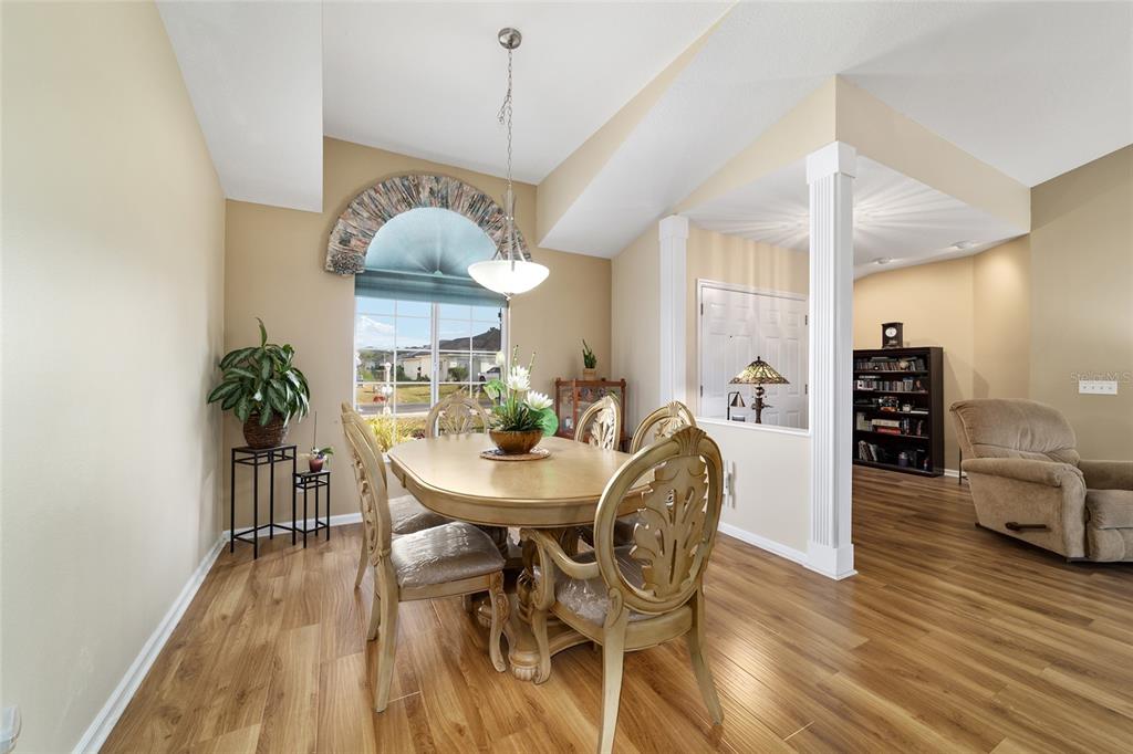 5245 Northwest 21st Loop Ocala, FL 34482 - Photo 8 of 26 a view of a dining room with furniture and wooden floor