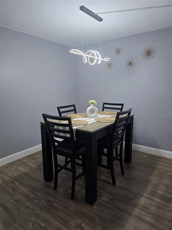 1624 South Pine Ridge Circle, Unit D2 Sanford, FL 32773 - Photo 11 of 14 a view of a dining room with furniture and wooden floor