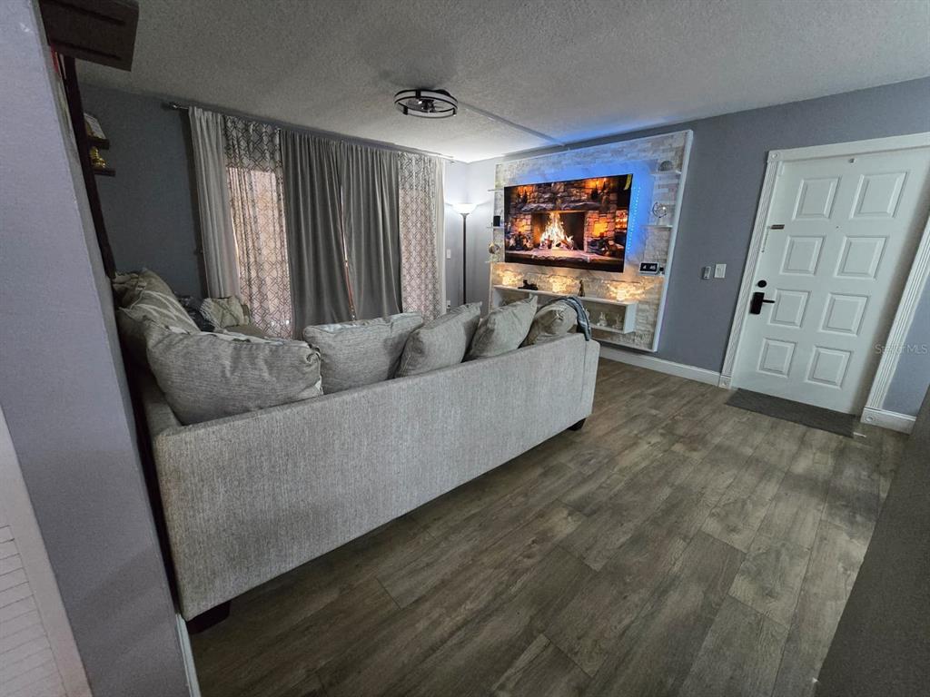 1624 South Pine Ridge Circle, Unit D2 Sanford, FL 32773 - Photo 2 of 14 a living room with furniture and a flat screen tv