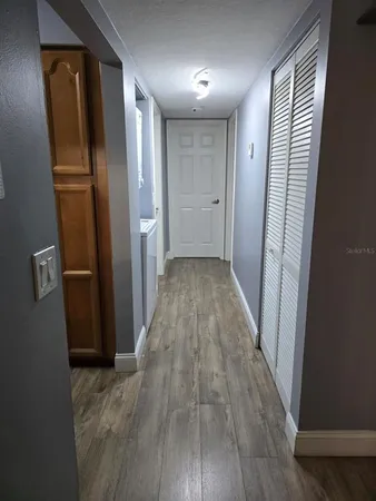 a view of hallway with wooden floor