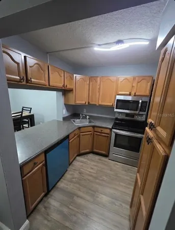 a kitchen with granite countertop a sink and cabinets