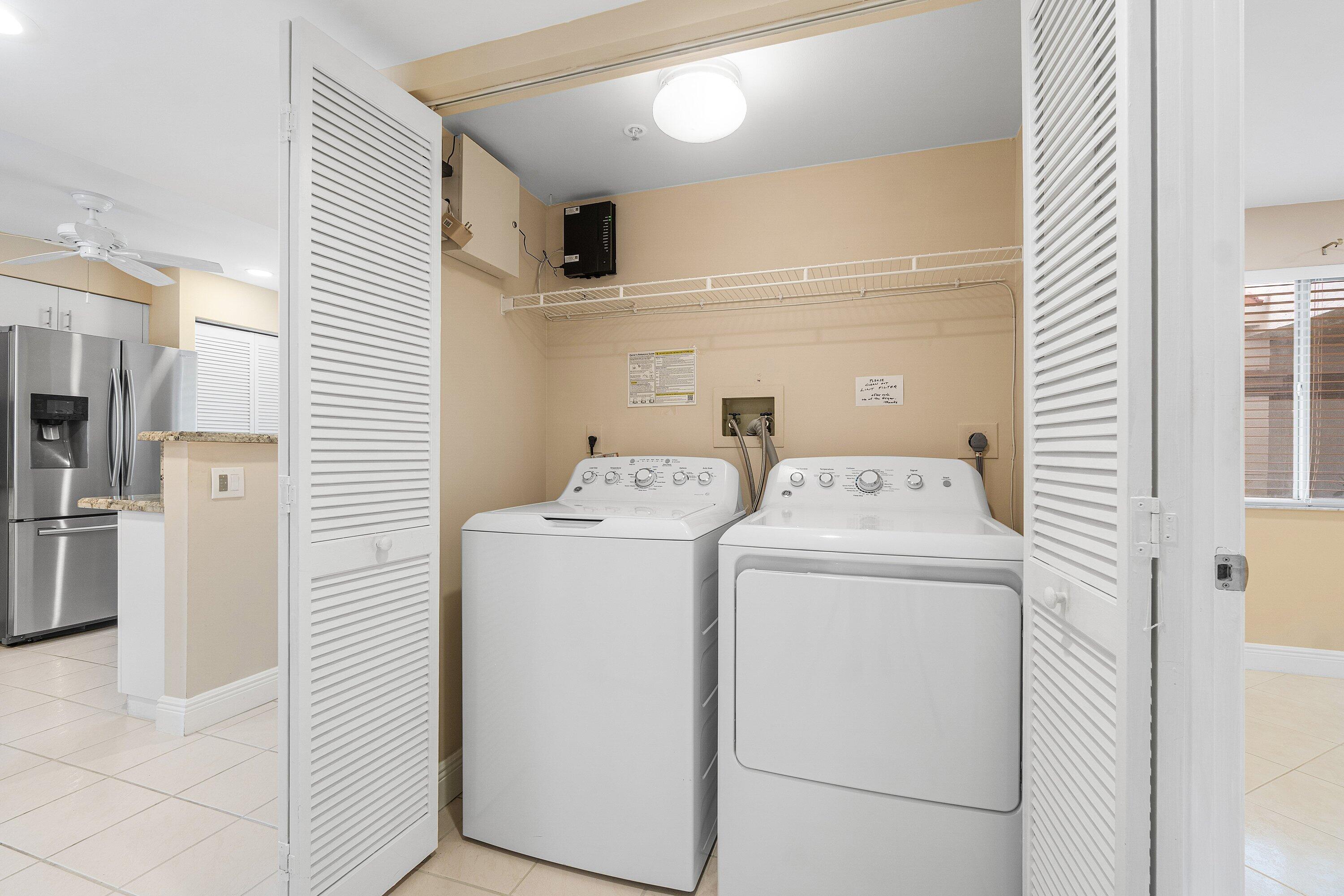 14096 Huntington Pointe Drive, Unit 106 Delray Beach, FL 33484 - Photo 33 of 47 a utility room with dryer and washer