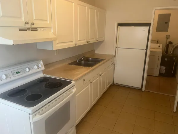 a kitchen with a sink a stove and a refrigerator