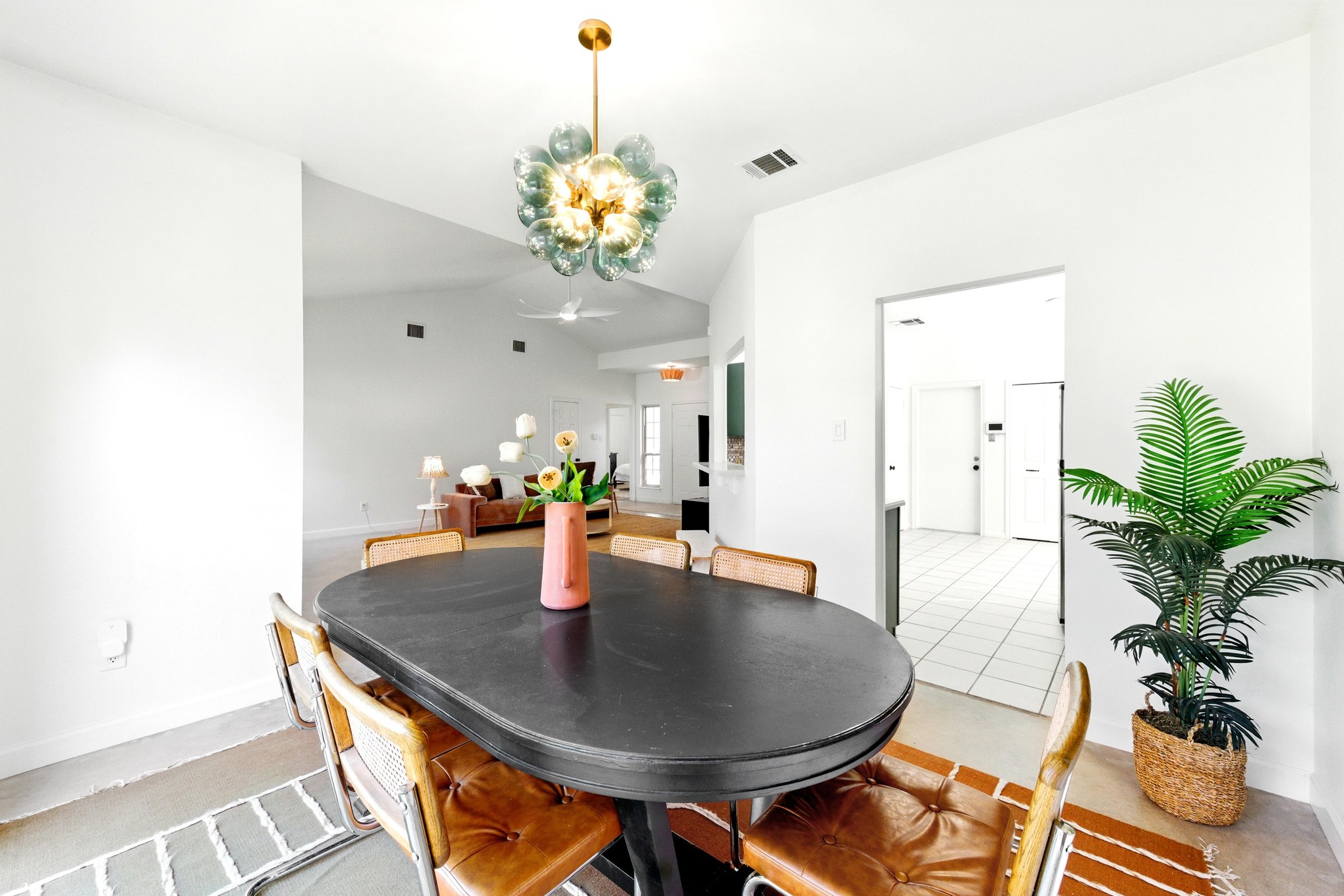 5807 Convict Hill Road Austin, TX 78749 - Photo 9 of 27 Sliding glass doors lead directly to the backyard, flooding the room with light and offering easy indoor-outdoor living. The eye-catching chandelier and colorful artwork bring a fresh pop of personality.