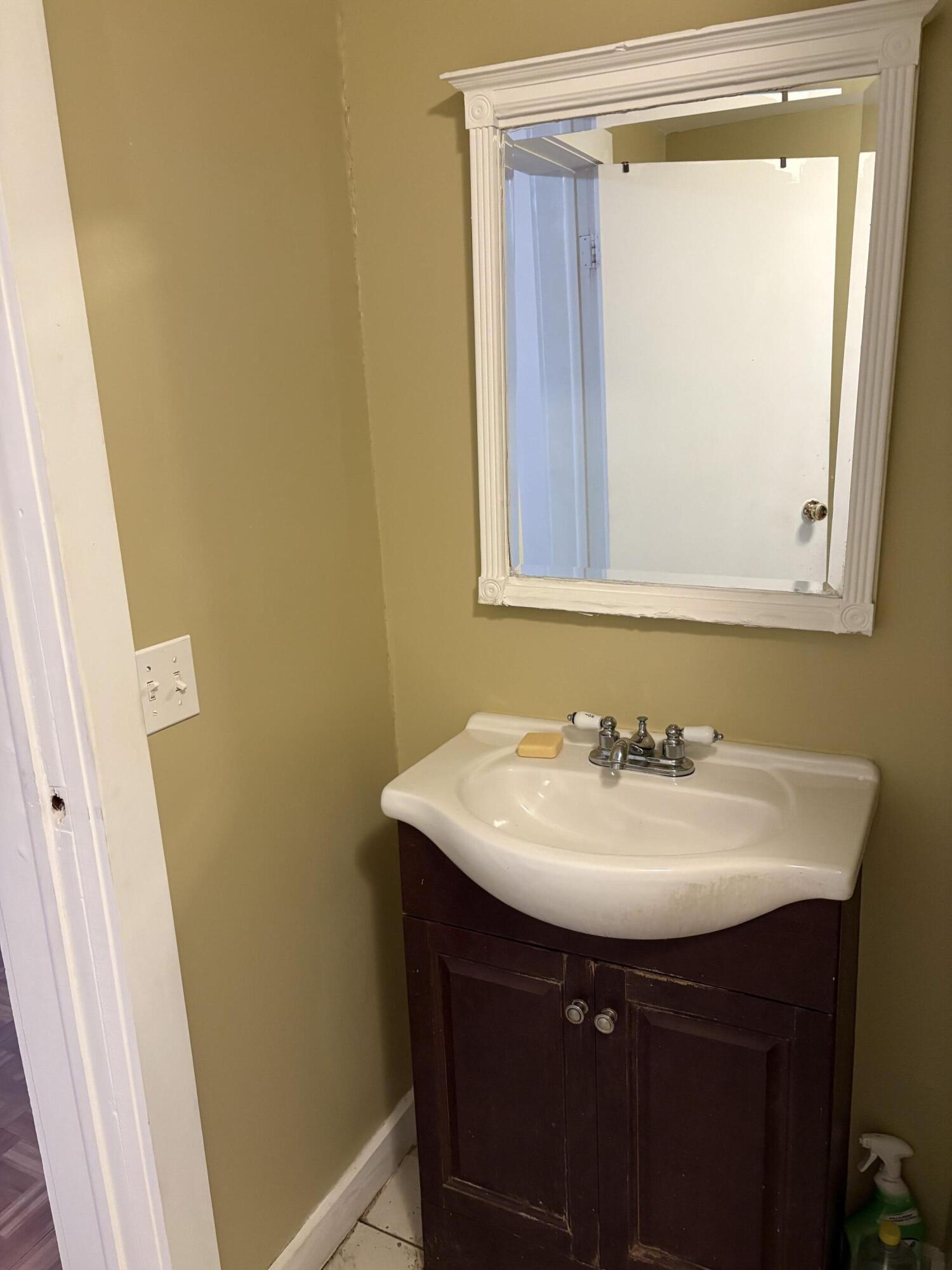 705 Chapman Lane Key West, FL 33040 - Photo 19 of 24 a bathroom with a sink and a mirror