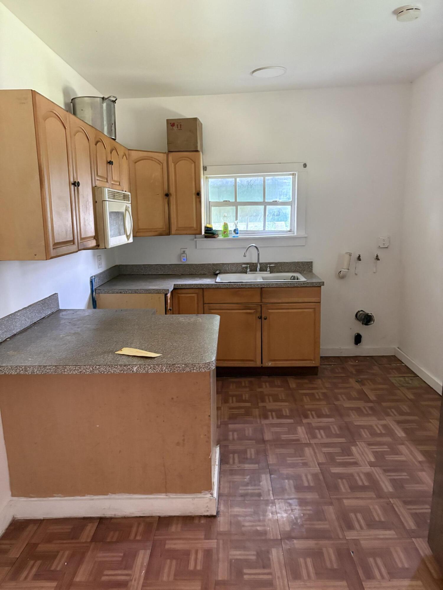 705 Chapman Lane Key West, FL 33040 - Photo 21 of 24 a view of a kitchen with stainless steel appliances granite countertop a sink and a stove